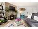 Living room featuring a stone fireplace with TV, comfortable seating, and stylish accents at 209 Wright St # 204, Lakewood, CO 80228