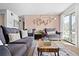 Inviting living room with stylish furniture, hexagon wall decor, and a balcony view at 209 Wright St # 204, Lakewood, CO 80228