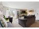 Bright living room with stone fireplace, TV, balcony access, and plush seating at 209 Wright St # 204, Lakewood, CO 80228