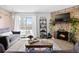 Cozy living room with a stone fireplace, mounted TV, stylish decor, and a sliding glass door to outdoor balcony at 209 Wright St # 204, Lakewood, CO 80228