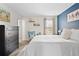 Tranquil main bedroom featuring a comfortable queen-sized bed and a dark blue accent wall, promoting relaxation at 209 Wright St # 204, Lakewood, CO 80228
