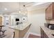 Basement bar features granite countertop and pendant lighting at 7902 E 49Th Pl, Denver, CO 80238