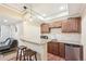 Basement wet bar with granite countertop, microwave, and mini-fridge at 7902 E 49Th Pl, Denver, CO 80238