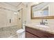 Basement bathroom with shower, toilet, and granite vanity at 7902 E 49Th Pl, Denver, CO 80238