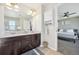 Bathroom with double vanity and a view into the bedroom at 7902 E 49Th Pl, Denver, CO 80238