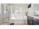 Main bathroom with soaking tub, shower, and double vanity at 7902 E 49Th Pl, Denver, CO 80238