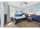 Nautically themed bedroom with twin bed, window, and decorative accents at 7902 E 49Th Pl, Denver, CO 80238