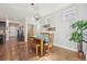 Bright dining area with hardwood floors and a wooden table with four chairs at 7902 E 49Th Pl, Denver, CO 80238
