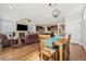Open concept dining room with hardwood floors and a view of the living room at 7902 E 49Th Pl, Denver, CO 80238