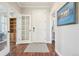 Bright and airy entryway with hardwood floors and access to multiple rooms at 7902 E 49Th Pl, Denver, CO 80238