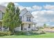 Two-story home with front porch and landscaping at 7902 E 49Th Pl, Denver, CO 80238