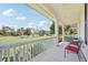 Relaxing front porch with white railings, chairs, and a view of the neighborhood at 7902 E 49Th Pl, Denver, CO 80238