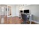 Dedicated home office space with built-in shelving and hardwood floors at 7902 E 49Th Pl, Denver, CO 80238