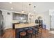 Modern kitchen with granite countertops, dark cabinets, and a large island at 7902 E 49Th Pl, Denver, CO 80238
