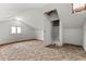 Large attic space with windows, sloped ceilings, and door with access to a closet at 2701 W Mississippi Ave, Denver, CO 80219