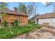 Backyard with brick home and detached garage needing maintenance at 2701 W Mississippi Ave, Denver, CO 80219