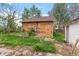 Backyard of brick home with overgrown weeds at 2701 W Mississippi Ave, Denver, CO 80219