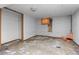 Unfinished basement space with concrete floors and a small window at 2701 W Mississippi Ave, Denver, CO 80219