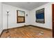Bedroom with hardwood floors, natural light, and an outdated window at 2701 W Mississippi Ave, Denver, CO 80219