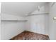 Small, sloped closet with carpeting and one shelf at 2701 W Mississippi Ave, Denver, CO 80219