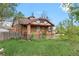 Brick single-Gathering home with a covered front porch and overgrown lawn at 2701 W Mississippi Ave, Denver, CO 80219