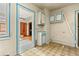 Outdated kitchen features white walls with blue trim, patterned floors, and cabinetry at 2701 W Mississippi Ave, Denver, CO 80219