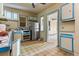 Outdated kitchen featuring blue and white cabinetry, patterned floors, and stainless steel refrigerator at 2701 W Mississippi Ave, Denver, CO 80219