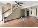 Spacious room with wood floors, a staircase, and a ceiling fan at 2701 W Mississippi Ave, Denver, CO 80219