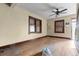 Interior room featuring original hardwood floors, multiple windows, and neutral wall color at 2701 W Mississippi Ave, Denver, CO 80219