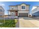 Two-story house with attached garage and landscaped front yard at 2262 Base St, Fort Lupton, CO 80621