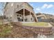 Landscaped backyard with retaining wall, level lawn and access to upper deck at 18189 House Finch Ln, Parker, CO 80134