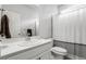 Bright bathroom featuring a white vanity, toilet and shower-tub combination at 18189 House Finch Ln, Parker, CO 80134