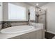 Relaxing bathroom featuring a soaking tub and glass-enclosed shower at 18189 House Finch Ln, Parker, CO 80134