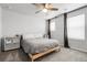 A bright bedroom with a full-sized bed, neutral walls, carpeted floors, and a ceiling fan at 18189 House Finch Ln, Parker, CO 80134