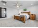 Primary bedroom with wood furniture, a ceiling fan, and a large mirror at 18189 House Finch Ln, Parker, CO 80134