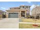 Charming two-story home with a well-maintained front yard and a welcoming entrance, including a two car garage at 18189 House Finch Ln, Parker, CO 80134