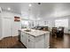 Open-concept kitchen with a large island, pendant lighting, stainless steel appliances, hardwood floors and seating for three at 18189 House Finch Ln, Parker, CO 80134