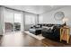 Comfortable living room featuring a plush sectional sofa, bright windows, and a sliding door to an outdoor space at 18189 House Finch Ln, Parker, CO 80134