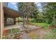 Covered patio overlooks a spacious backyard with garden beds, perfect for outdoor entertaining at 930 S Dayton St, Denver, CO 80247