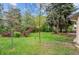 Spacious backyard featuring a lush lawn and mature trees, creating a serene and private outdoor space at 930 S Dayton St, Denver, CO 80247