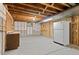 Basement features concrete floor, shelving, utility sink, and includes a refrigerator at 930 S Dayton St, Denver, CO 80247