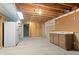 Partially finished basement with a refrigerator and plenty of potential storage space at 930 S Dayton St, Denver, CO 80247