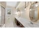 Bathroom features a double sink vanity with decorative mirrors and updated lighting at 930 S Dayton St, Denver, CO 80247
