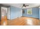 Large bedroom featuring blue walls and hardwood floors at 930 S Dayton St, Denver, CO 80247