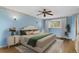 Serene bedroom features hardwood floors, soft lighting, and a large window at 930 S Dayton St, Denver, CO 80247