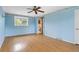 Spacious bedroom featuring blue walls and hardwood floors at 930 S Dayton St, Denver, CO 80247