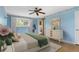 Charming bedroom with hardwood floors, a ceiling fan and a large window at 930 S Dayton St, Denver, CO 80247