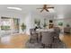 Sunlit dining area with hardwood floors and a view of the outdoor patio at 930 S Dayton St, Denver, CO 80247