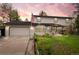 Charming two-story home featuring an attached garage and a well-maintained front yard with an American flag at 930 S Dayton St, Denver, CO 80247