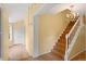 Bright foyer with hardwood floors, staircase with white railing, and a charming chandelier at 930 S Dayton St, Denver, CO 80247